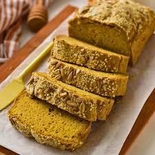 “Sliced gluten-free multigrain bread loaf with seeds on top.”